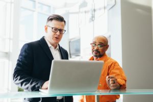 two men playing a video of a recorded Intranet Demo