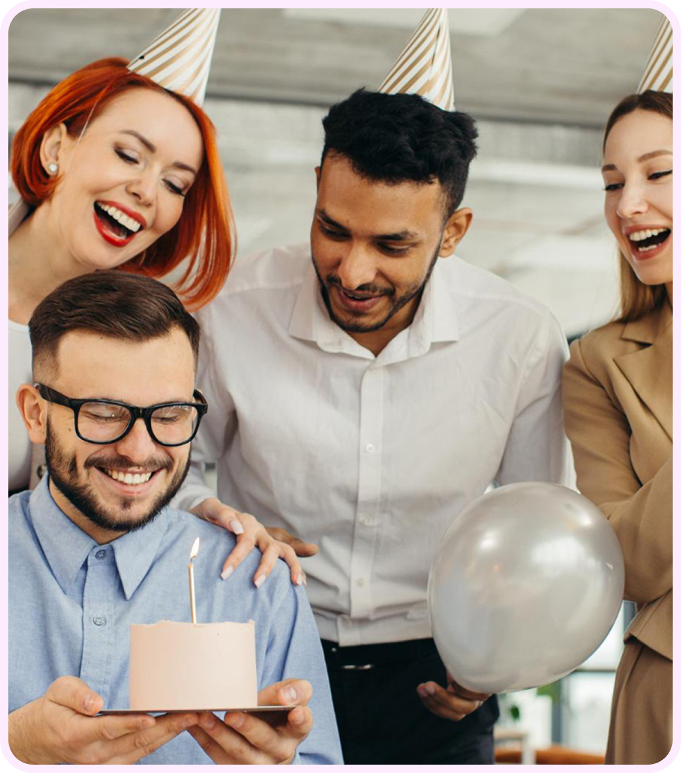 Colleagues celebrating a milestone with party hats and cake